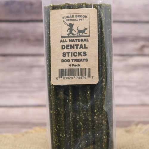 Close-up of Sugar Brook Natural Pet Dental Sticks in clear packaging, highlighting the green, textured dog treats.