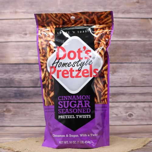 A 16oz purple plastic bag with black accents and a picture of pretzel sticks, sitting on a burlap material with wood background