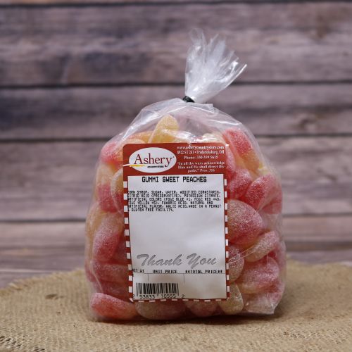 Clear plastic Ashery bag with red and white sticker label filled with orange candies, sitting on a burlap material with wood background
