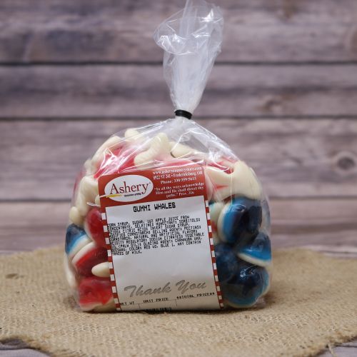 Clear plastic Ashery bag with red and white sticker label filled with colorful candies, sitting on a burlap material with wood background