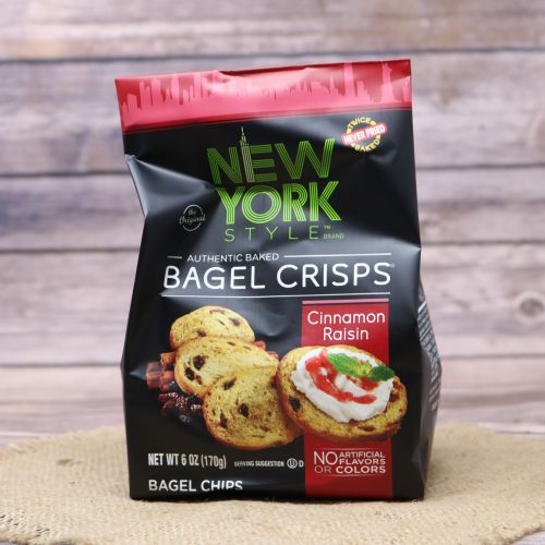 Black plastic bag with red accents and a picture of New York style bagel crisps, sitting on a burlap material with wood background