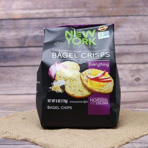 Black plastic bag with purple accents and a picture of New York style bagel crisps, sitting on a burlap material with wood background