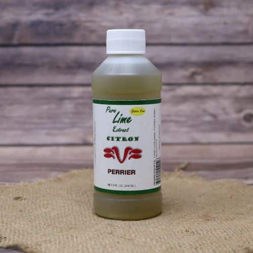 Small 8oz plastic bottle of green liquid with a white and green sticker label, sitting on a burlap material with wood background