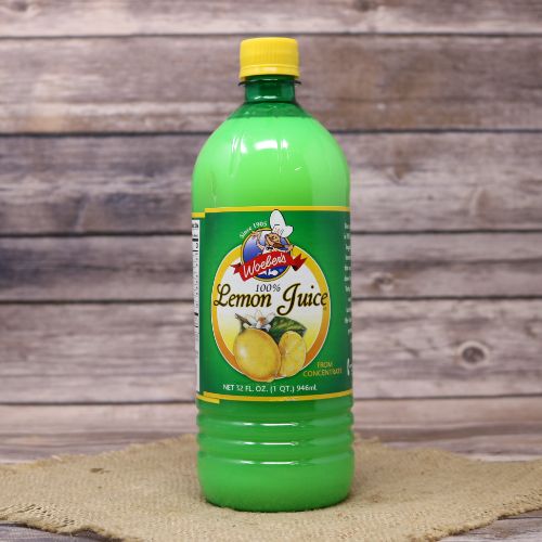 A 32 ounce green plastic bottle with a green and yellow label and a yellow screw on cap, sitting on a burlap material with wood background