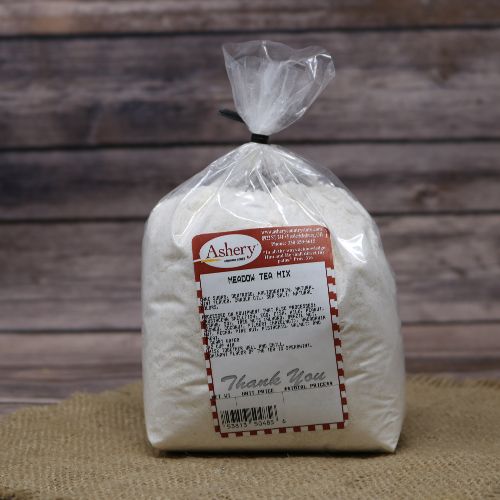 Clear plastic Ashery bag with red and white sticker label filled with a white tea mix, sitting on a burlap material with wood background