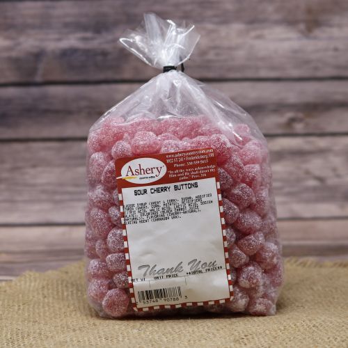 Clear plastic Ashery bag with red and white sticker label filled with red candies sitting on a burlap material with wood background