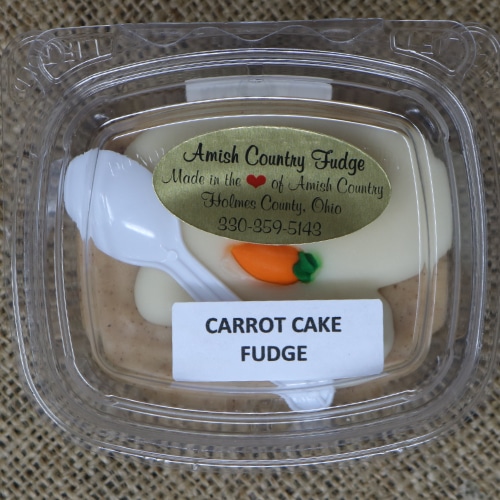 Close-up of a package of Amish Country Fudge Carrot Cake flavor with a small plastic spoon.