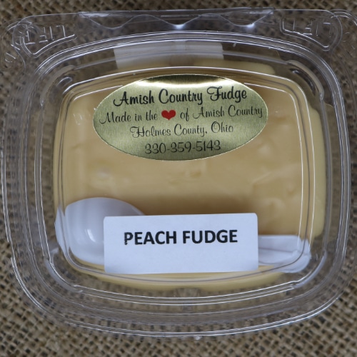 Close-up of a package of Amish Country Fudge Peach flavor with a small plastic spoon.
