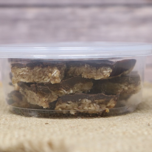 Side view of a container of Ashery's Own Dark Chocolate Almond Butter Bites.