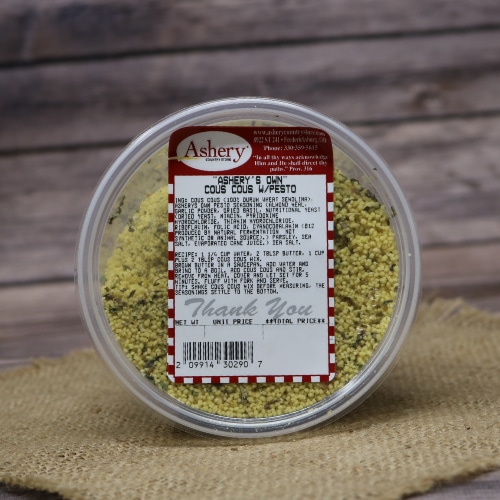 Container of Ashery's Own Cous Cous with Pesto on a burlap mat with a rustic wooden background.