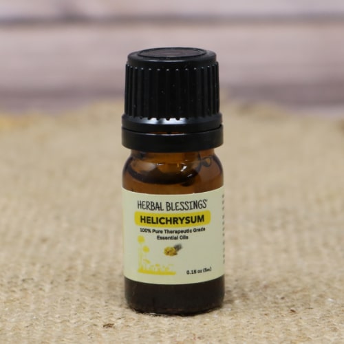 Close-up of a bottle of Herbal Blessings Helichrysum essential oil.