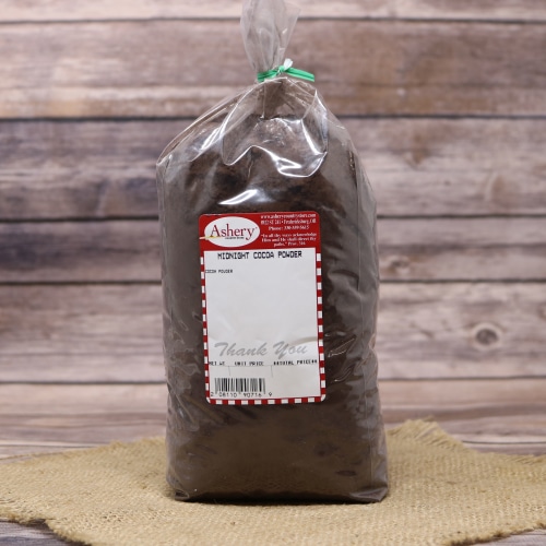 Bag of Midnight Cocoa Powder from Ashery Country Store on a rustic wooden background.