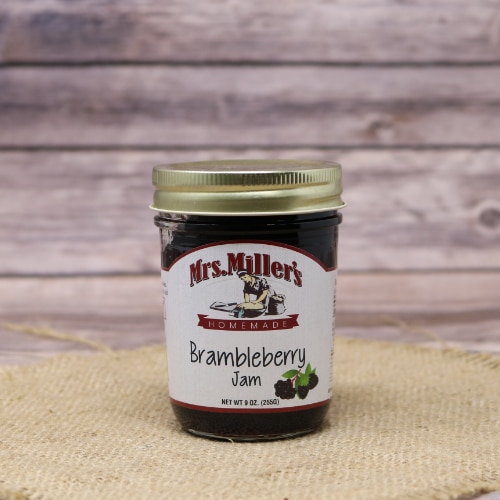 Jar of Mrs. Miller's Homemade Brambleberry Jam with a white label and gold lid, set against a rustic wood backdrop