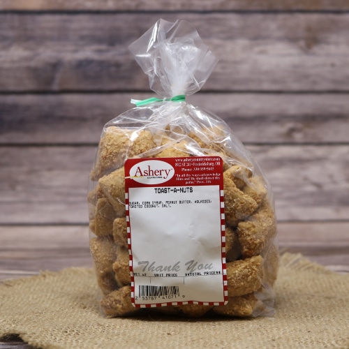 Bag of Ashery Toast-a-Nuts on a burlap mat with a rustic wooden background.